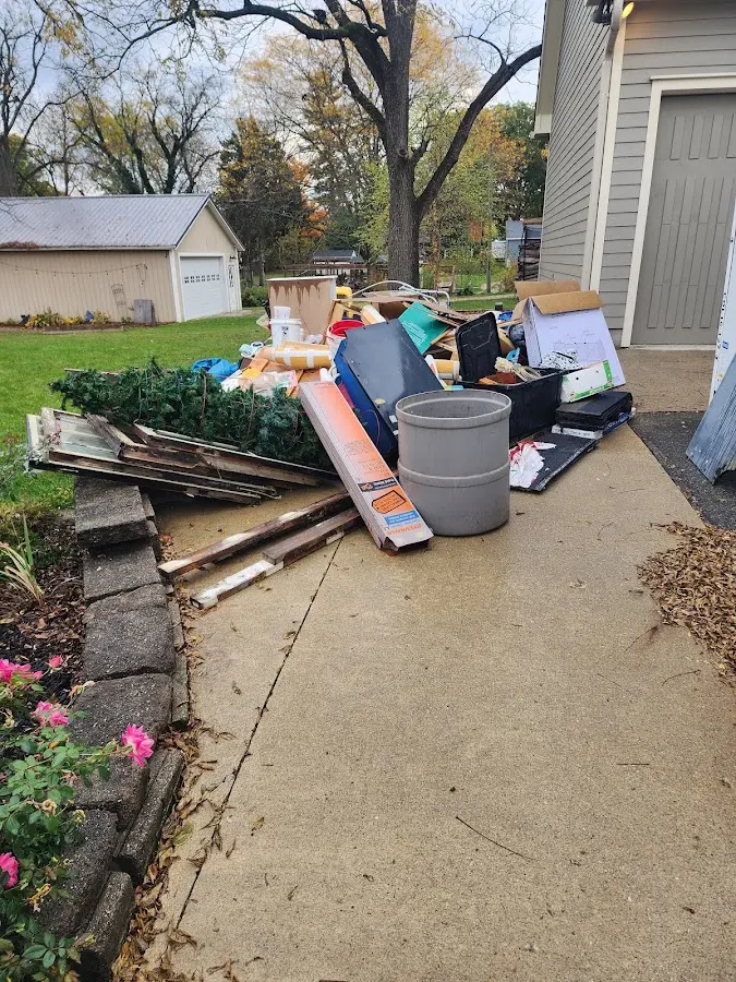 Dumpster being loaded with debris for Roofing Dumpster Rental in Lynchburg, Moore County